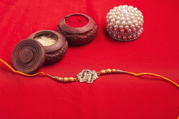 Indian festival Raksha Bandhan A traditional Indian wrist band on red background