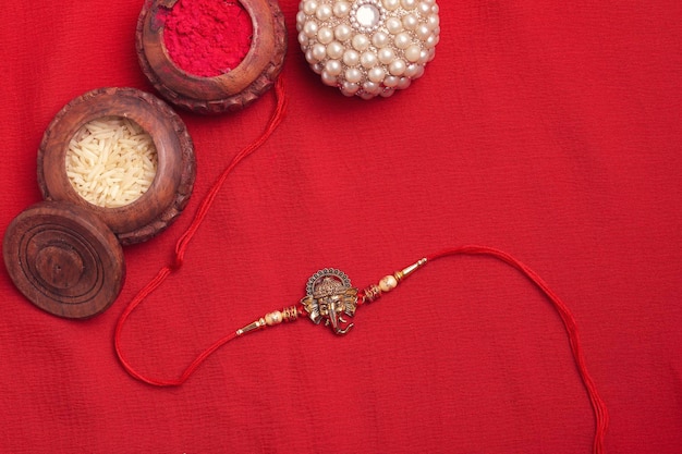 Indian festival Raksha Bandhan A traditional Indian wrist band on red background