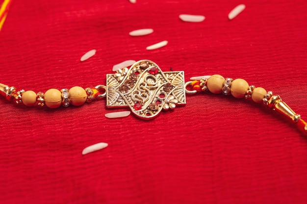 Indian festival Raksha Bandhan A traditional Indian wrist band on red background