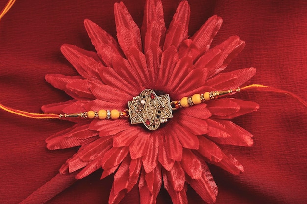 Indian festival Raksha Bandhan A traditional Indian wrist band on red background