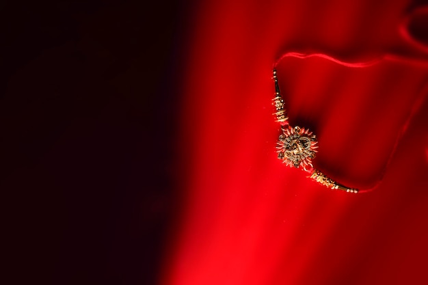 Indian festival Raksha Bandhan A traditional Indian wrist band on red background