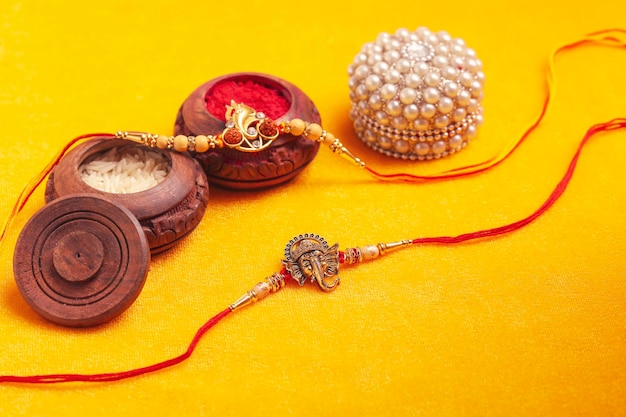 Indian festival Raksha Bandhan A traditional Indian wrist band on yellow background