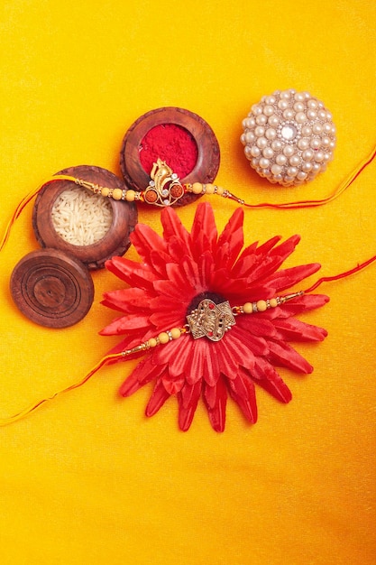 Indian festival Raksha Bandhan A traditional Indian wrist band on yellow background