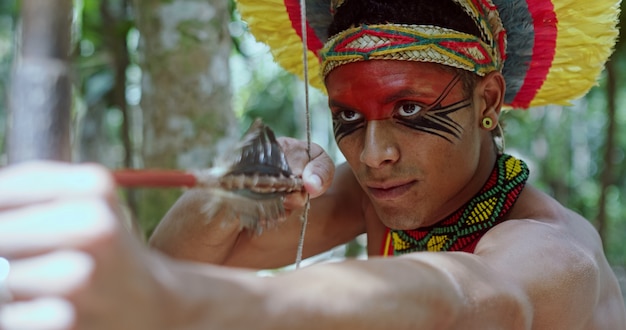 indian from the pataxo tribe using a bow and arrow indians day brazilian indian