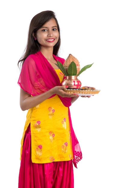 Indian girl holding a traditional copper Kalash with Pooja Thali, Indian Festival