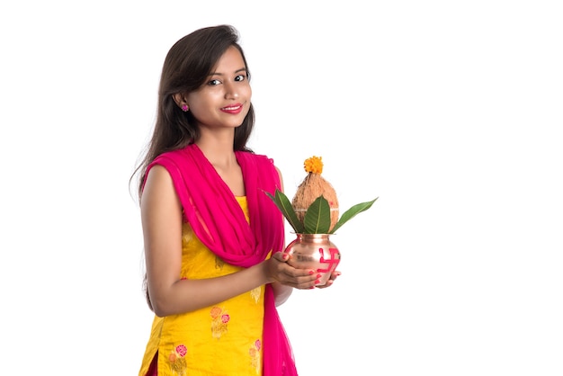 Indian girl holding a traditional copper Kalash