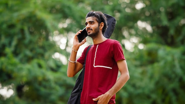 Indian Guitarist Boy is talking on the phone