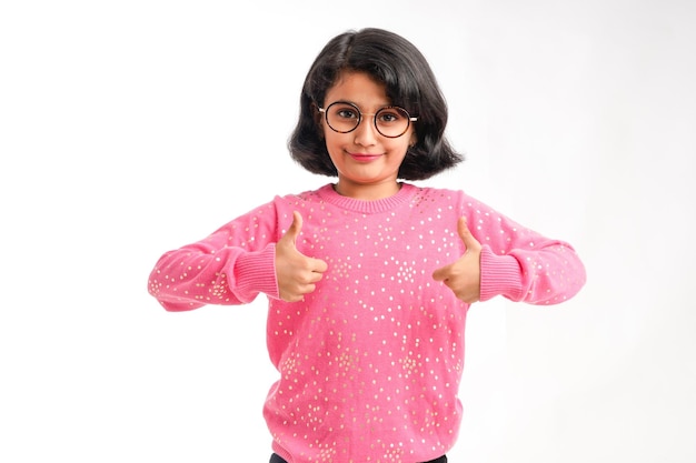 Indian little girl showing thumps up on white background