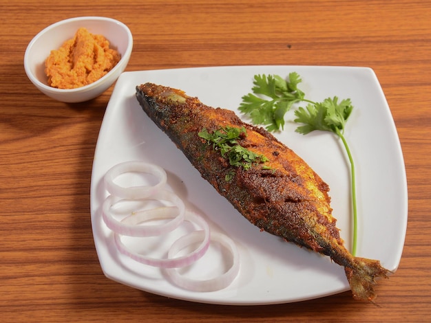 The Indian mackerel Rastrelliger kanagurta Bangda fry Fish fry on a rustic wooden background selective focus