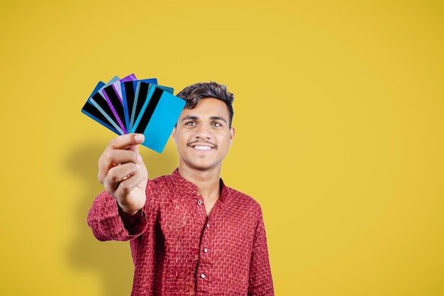 Indian man holding bank card or business card