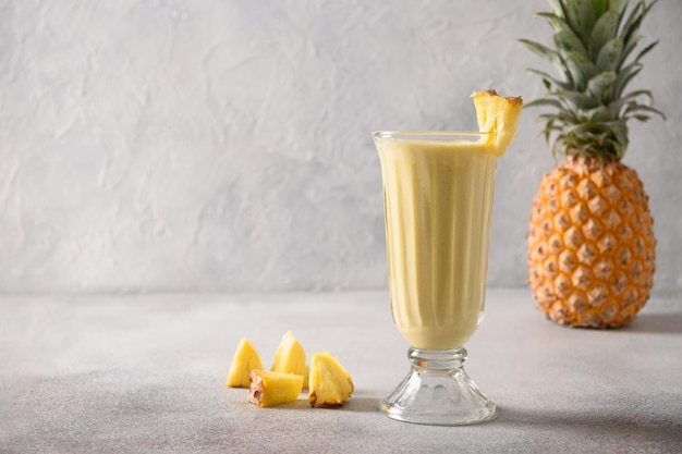 Indian mango or turmeric lassi on gray background