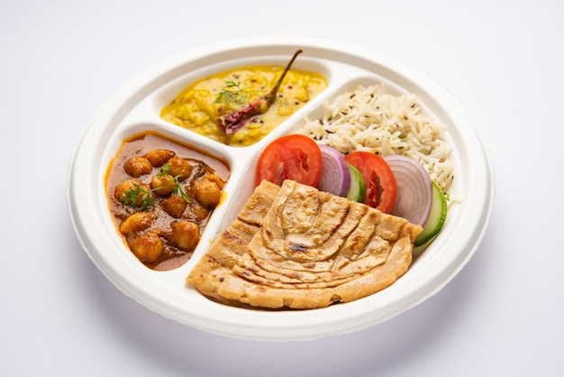 Indian mini meal parcel platter combo thali with chole Masala roti dal tarka jeera rice salad