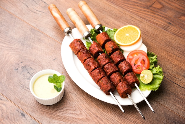 Indian Mutton Seekh Kabab served with green salad, selective focus