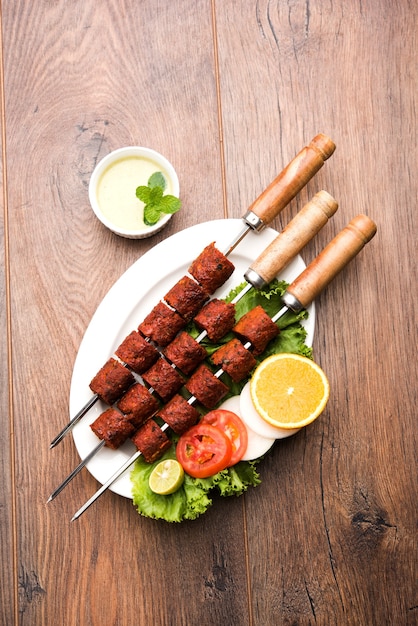 Indian Mutton Seekh Kabab served with green salad, selective focus