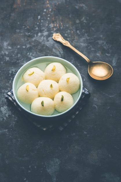 Indian Rasgulla or Rosogulla dessert sweet served in a bowl. selective focus