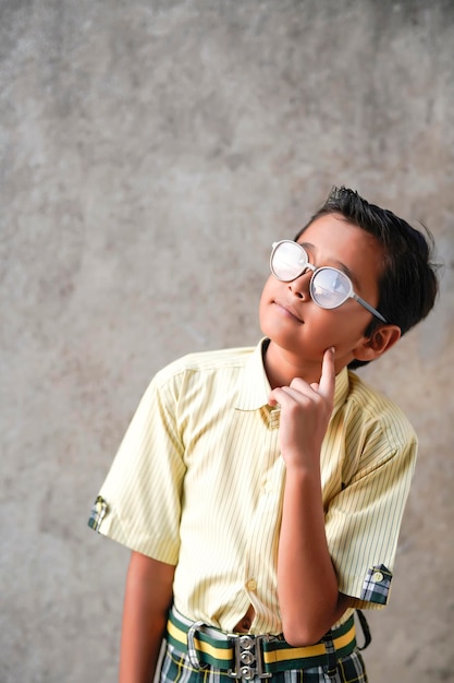 Indian school boy giving thinking gesture