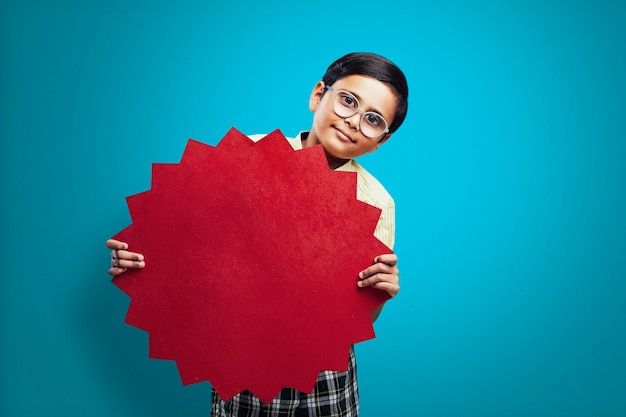 Indian school boy showing board with copy space