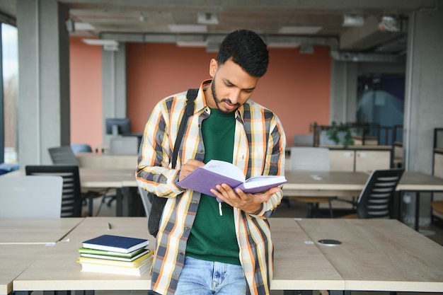 Indian student with books at university