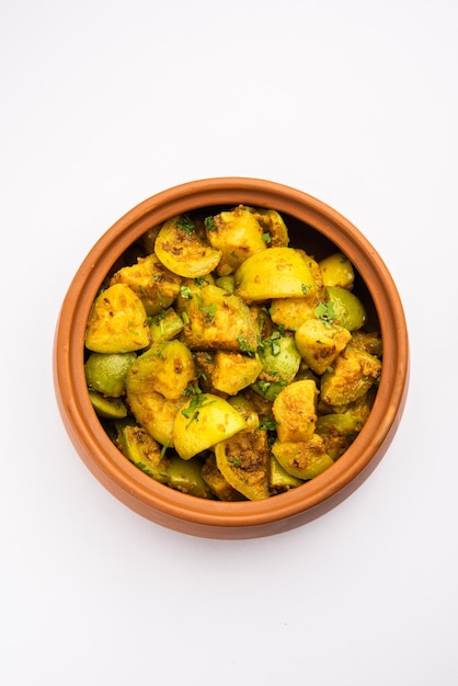 Indian style Tinda or Tinde ki Sabzi also called Indian squash round melon Indian round gourd or Indian baby pumpkin stuffed stir fried dry or curry recipe