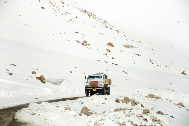 Indian and tibetan drive car and colorful truck on Khardung La Road in Himalaya mountain go to Nubra valley and Pangong lake at Leh Ladakh in Jammu and Kashmir India