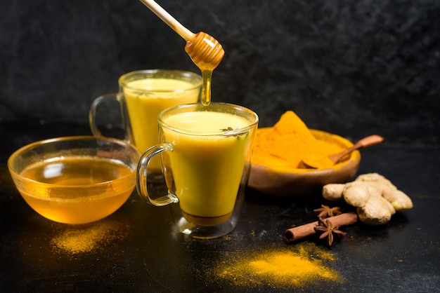 Indian traditional Golden milk with turmeric, ginger, spices, honey.