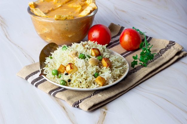 Indian Veg biryani or veg pulav with cheese and green peas