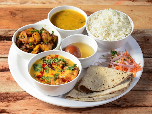 Indian Veg Rajasthani Thali food platter consists variety of veggies lentils sweet dish snacks etc selective focus