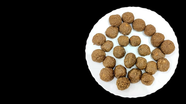 Indian white sesame seeds sweet or tilgul laddu made up of jaggery and sesame seeds hand made round indian sweet on Makar Sankranti festival