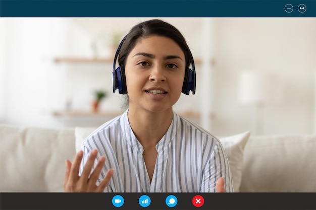 Photo indian woman in earphones talk on video call