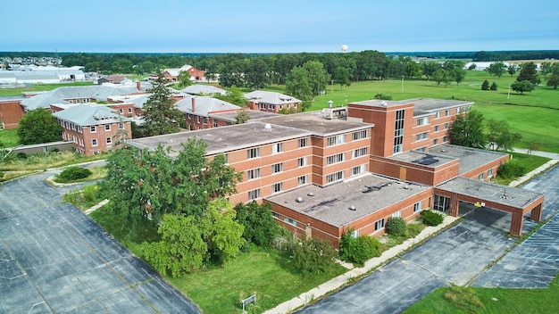 Indiana abandoned Byron Health hospital aerial of brick complex