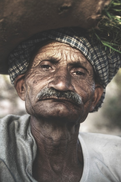 Indigenous senior Indian man looking grumpy at the camera.