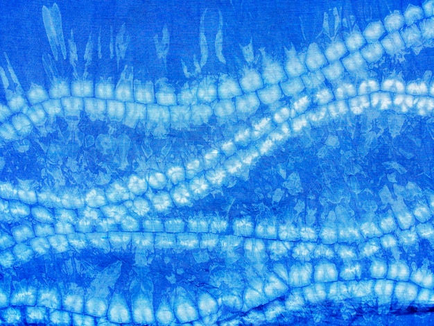 Indigo blue fabric tie dye pattern background. Indigo-Dyed fabric texture with abstract ethnic graphic motif pattern.