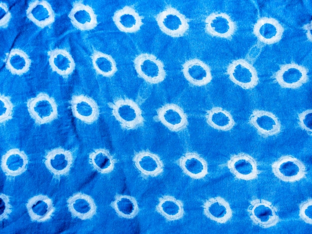 Indigo blue fabric tie dye pattern background. Indigo-Dyed fabric texture with abstract ethnic graphic motif pattern.