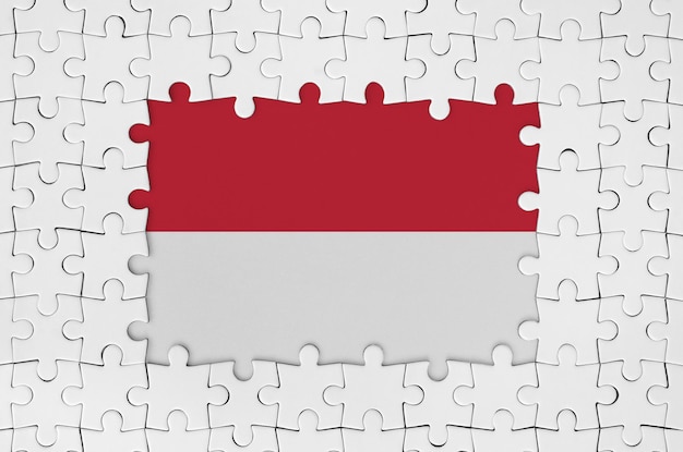 Indonesia flag in frame of white puzzle pieces with missing central part