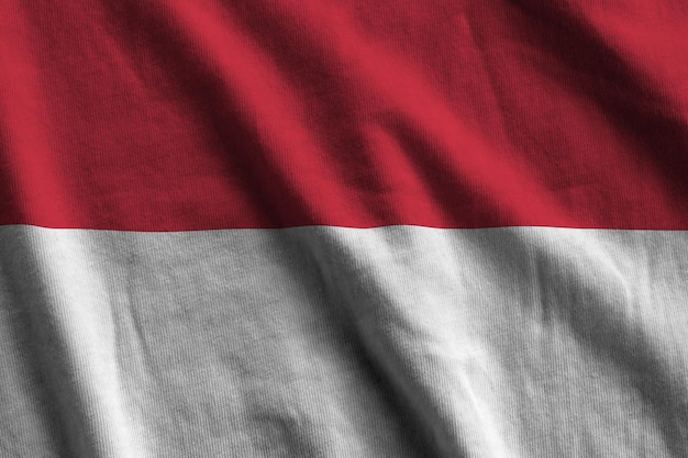 Indonesia flag with big folds waving close up under the studio light indoors The official symbols and colors in banner