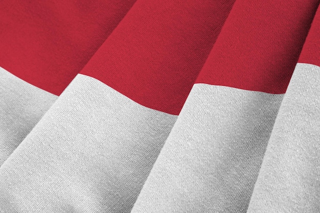 Indonesia flag with big folds waving close up under the studio light indoors The official symbols and colors in banner