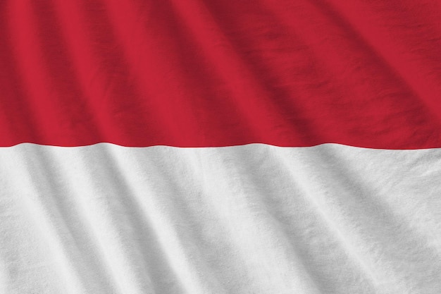 Indonesia flag with big folds waving close up under the studio light indoors The official symbols and colors in banner