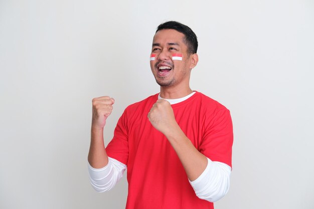 Indonesian man clenched both fist showing excitement during independence day celebration