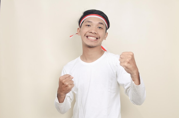 Indonesian man clenched both fist showing excitement when celebrating independence day