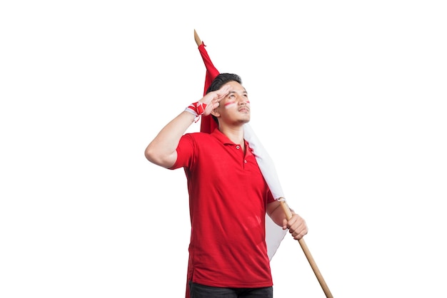 Indonesian men celebrate Indonesian independence day on 17 August by holding the Indonesian flag with respectful gestures