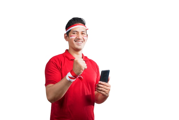 Indonesian men celebrate Indonesian independence day on 17 August while holding mobile phones