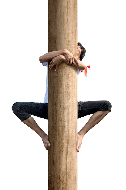 Indonesian men celebrate Indonesian independence day on 17 August with a climb competition isolated over white background