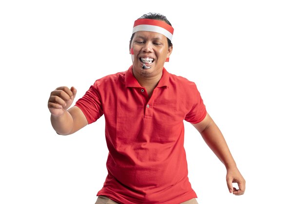 Indonesian men celebrate Indonesian independence day on 17 August with a marbles race using a spoon