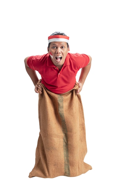 Indonesian men celebrate Indonesian independence day on 17 August with a sack race