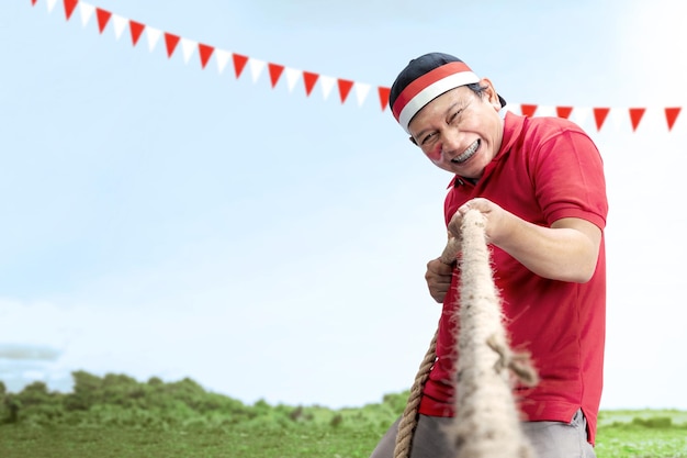 Indonesian men celebrate Indonesian independence day on 17 August with the tug of war contest Indonesian independence day