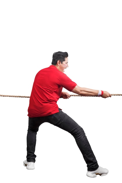 Indonesian men celebrate Indonesian independence day on 17 August with the tug of war contest