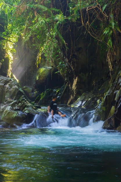 Indonesian natural scenery with a beautiful waterfall in the middle of a tropical forest