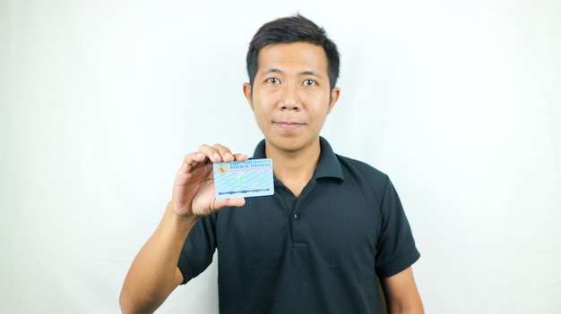 Indonesian people holding Indonesian identity cards KTP Kartu Tanda Penduduk