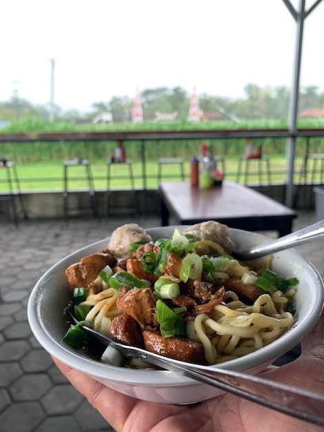 Indonesian street food Mie Ayam noodles with chicken