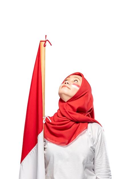 Indonesian women celebrate Indonesian independence day on 17 August by holding the Indonesian flag